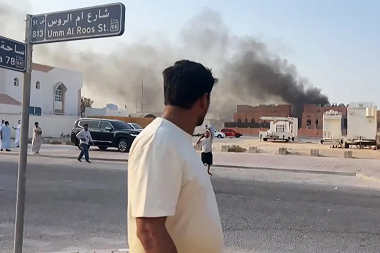 Israel's attack on Qatar was an escalation, but its invasion of Gaza City 1 A few people in traditional white Qatari attire can be seen near the vehicles, observing the scene.